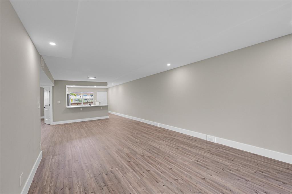 Lucaya Village Condominiums Coconut Creek, FL 33066 - Photo 23 of 28 a view of an empty room with wooden floor and a window