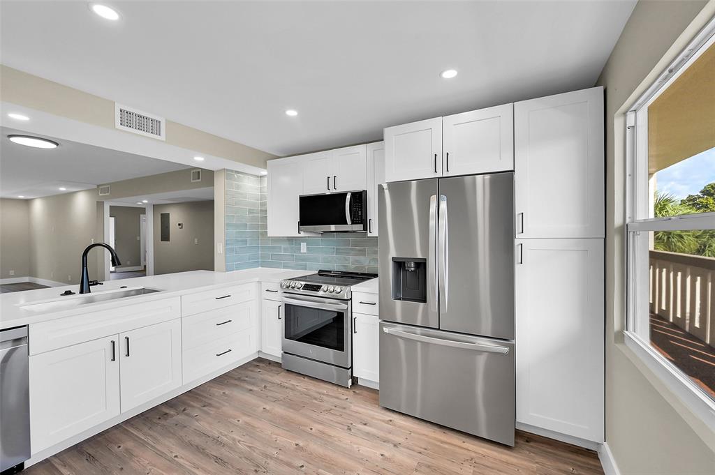 Lucaya Village Condominiums Coconut Creek, FL 33066 - Photo 4 of 28 a kitchen with stainless steel appliances granite countertop a refrigerator sink and stove