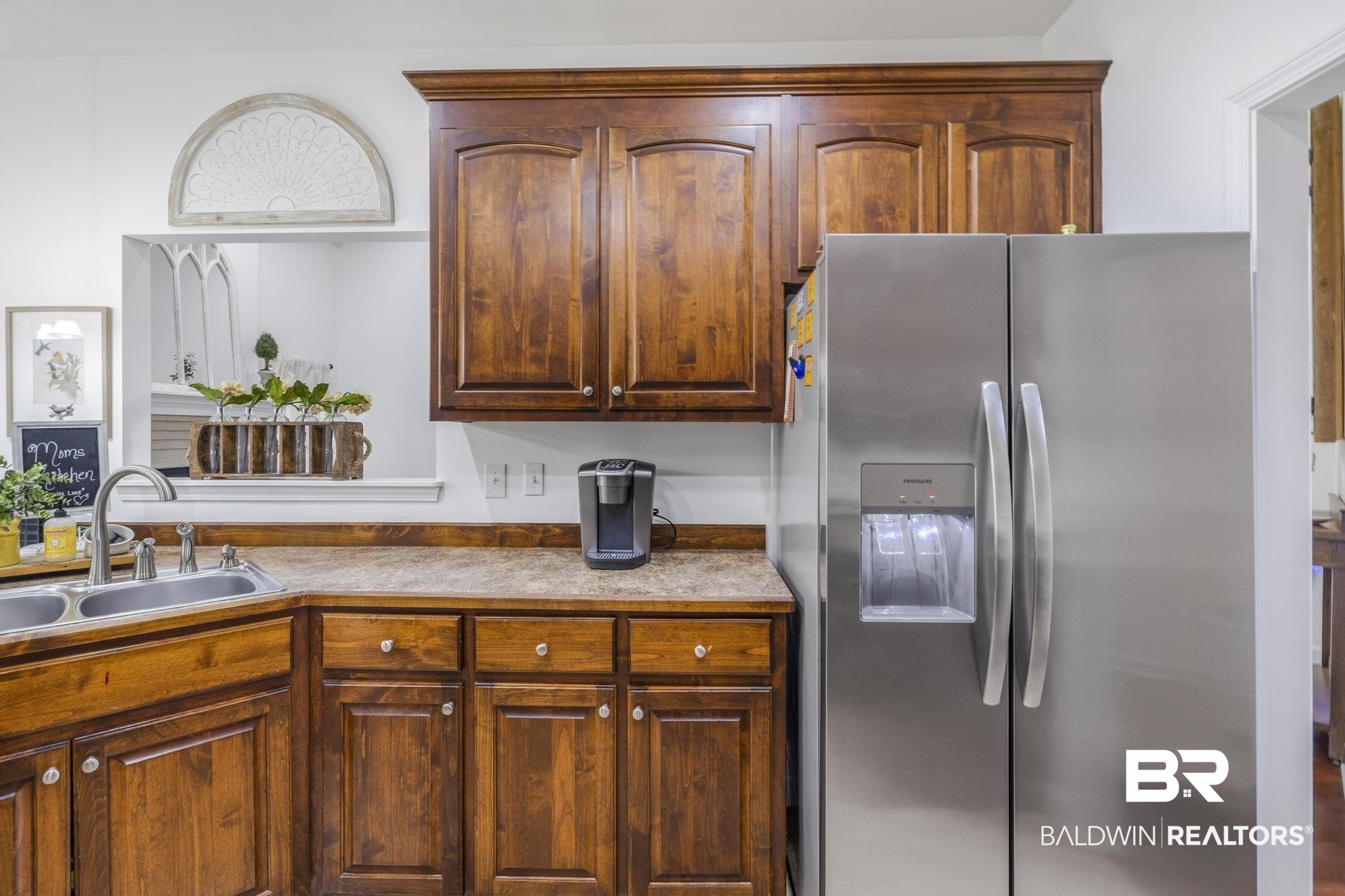 35814 Delvan Lane Bay Minette, AL 36507 - Photo 24 of 53 Kitchen featuring wood cabinetry, stainless steel side-by-side refrigerator with water and ice dispenser, double basin stainless steel sink with gooseneck faucet, and a pass-through window