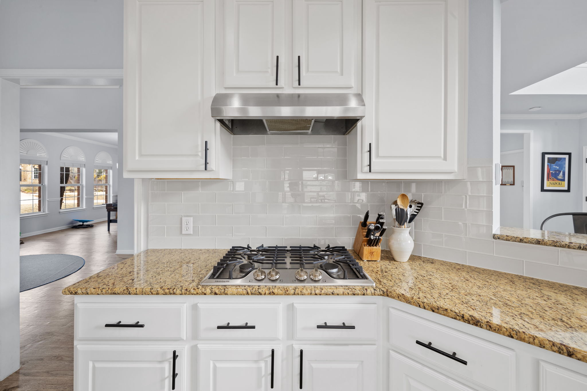 136 Eaton Lane Austin, TX 78737 - Photo 13 of 40 a kitchen with granite countertop stainless steel appliances sink stove and cabinets