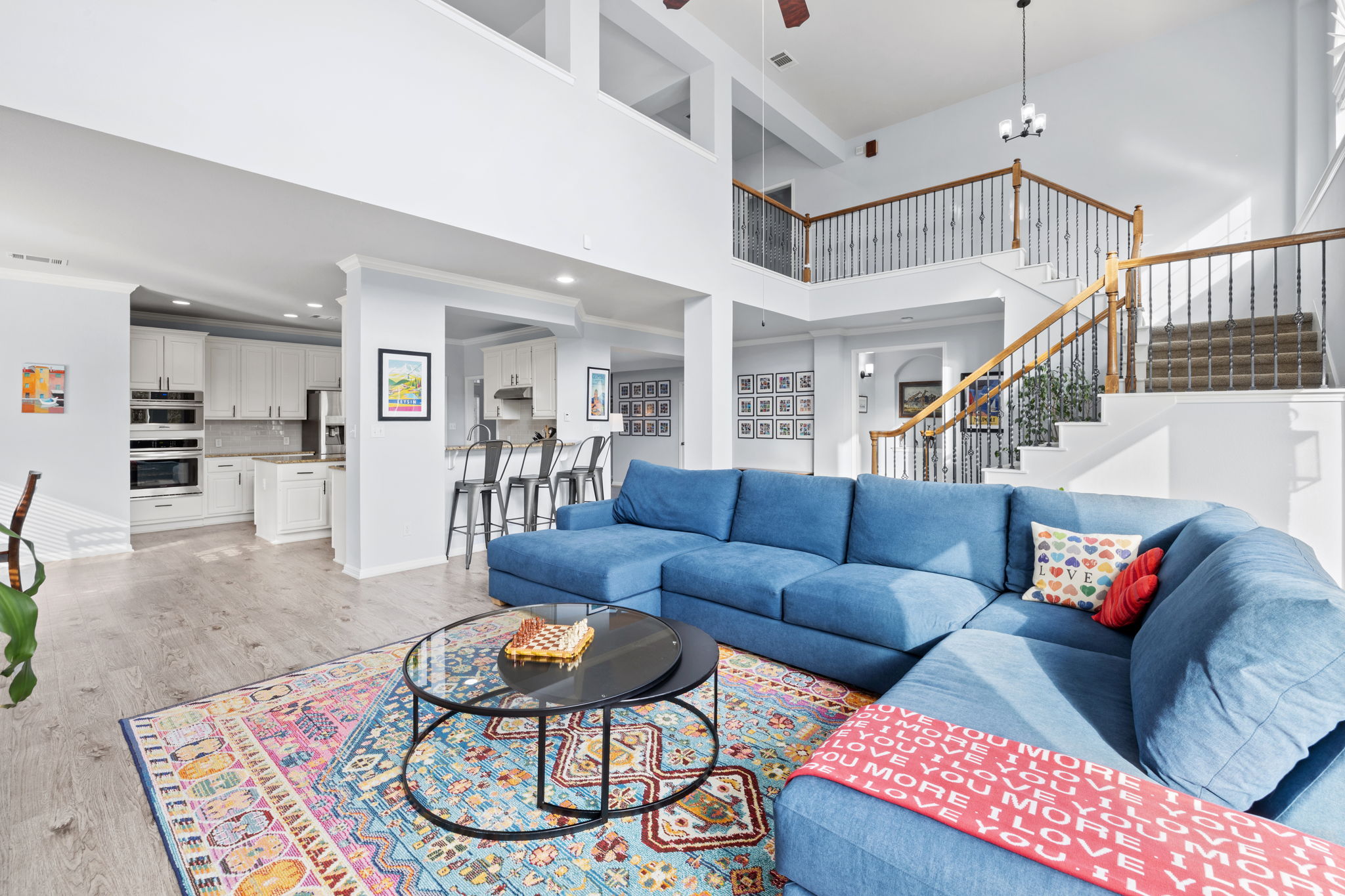136 Eaton Lane Austin, TX 78737 - Photo 16 of 40 a living room with furniture kitchen view and a wooden floor