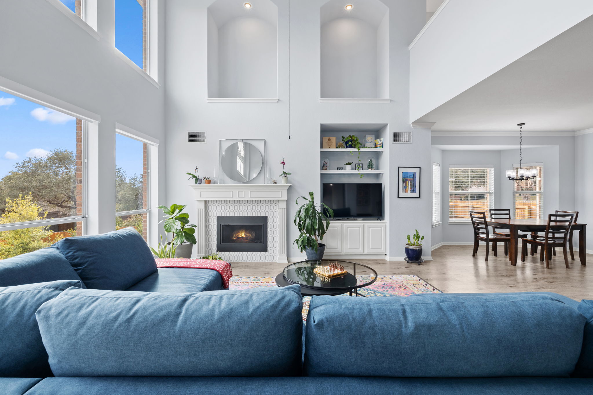 136 Eaton Lane Austin, TX 78737 - Photo 17 of 40 a living room with fireplace furniture and a large window