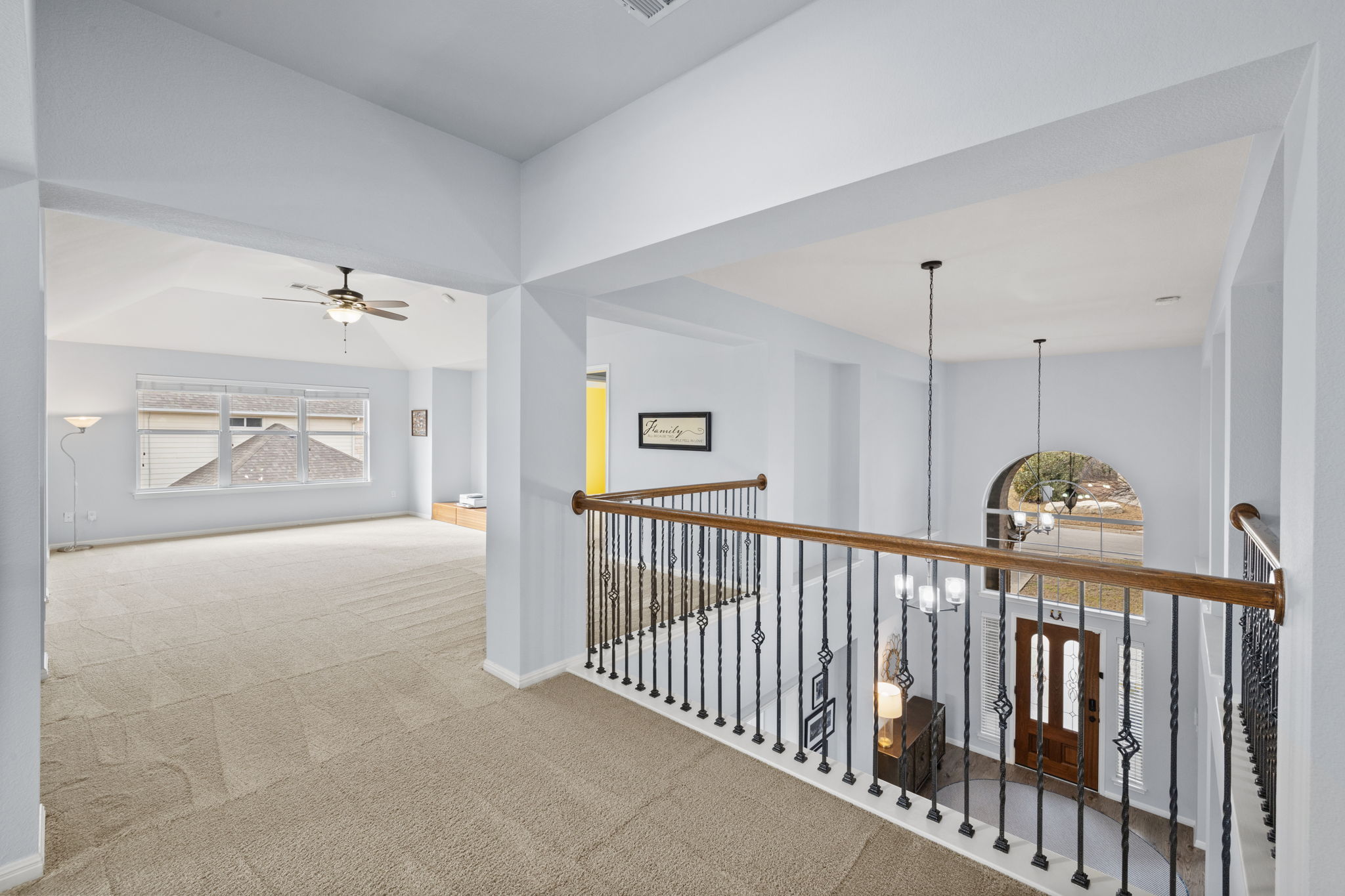 136 Eaton Lane Austin, TX 78737 - Photo 23 of 40 a view of staircase with a lots of frames on the wall