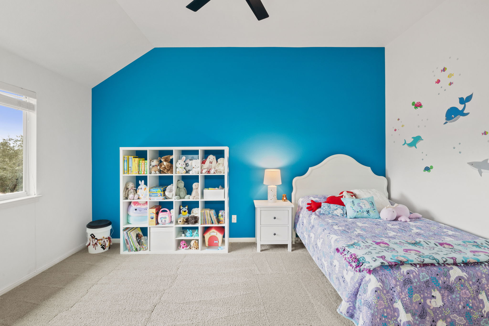 136 Eaton Lane Austin, TX 78737 - Photo 28 of 40 a bed room with a bed and a book shelf