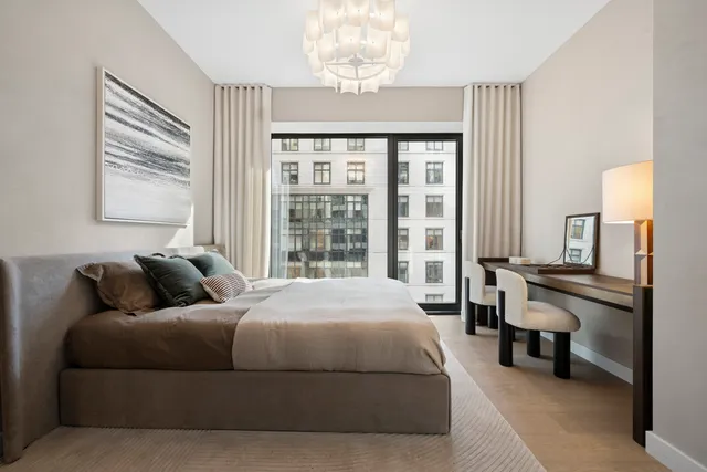 a bedroom with a large bed and a large window