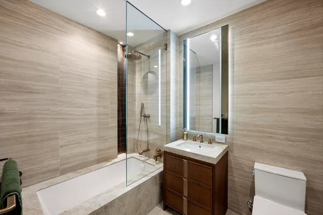 a bathroom with a double vanity sink toilet and shower