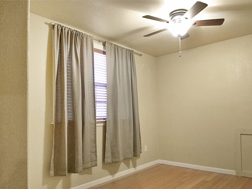 16219 Oxbow Trail, Unit UPSTAIRS Buda, TX 78610 - Photo 7 of 7 an empty room with windows and fan