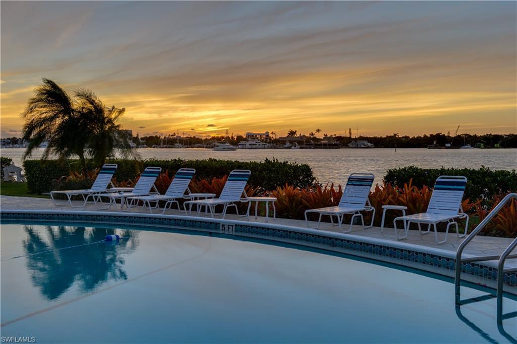 a view of swimming pool with outdoor seating