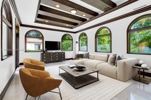 a view of a livingroom with furniture and chandelier fan