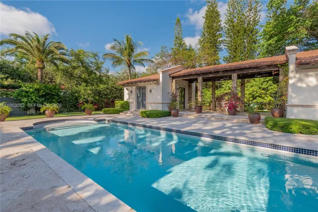 a swimming pool with outdoor seating and yard