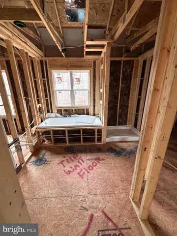 a living room with a bed furniture and a fireplace