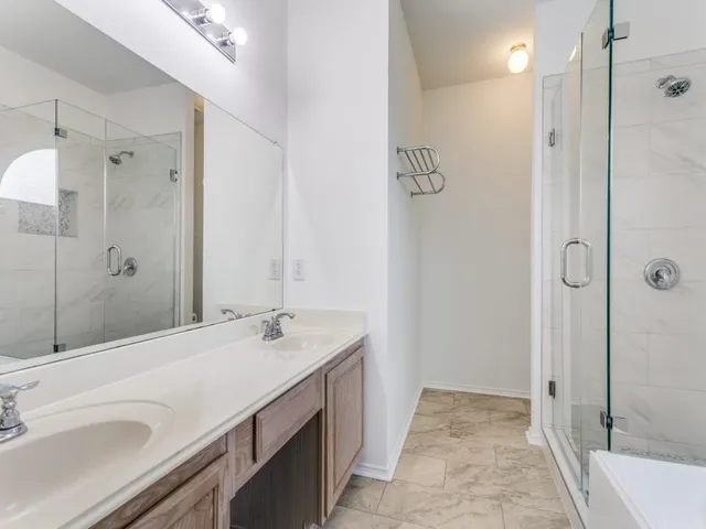 a bathroom with a sink and a mirror with bathtub
