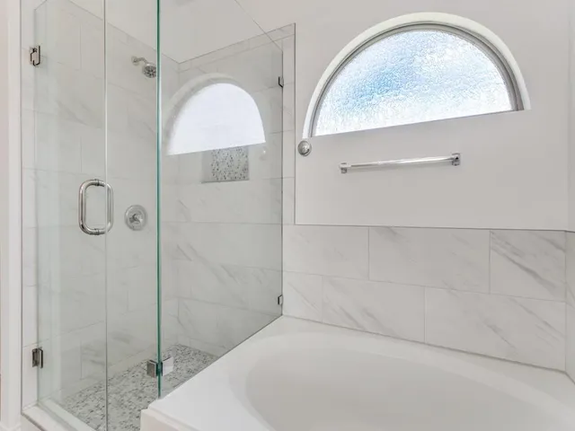 a bathroom with a balcony a sink and a mirror