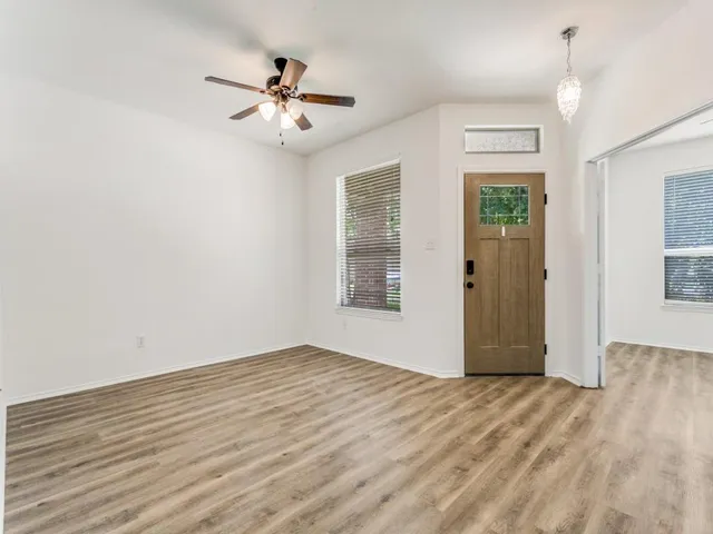 a view of an empty room with wooden floor