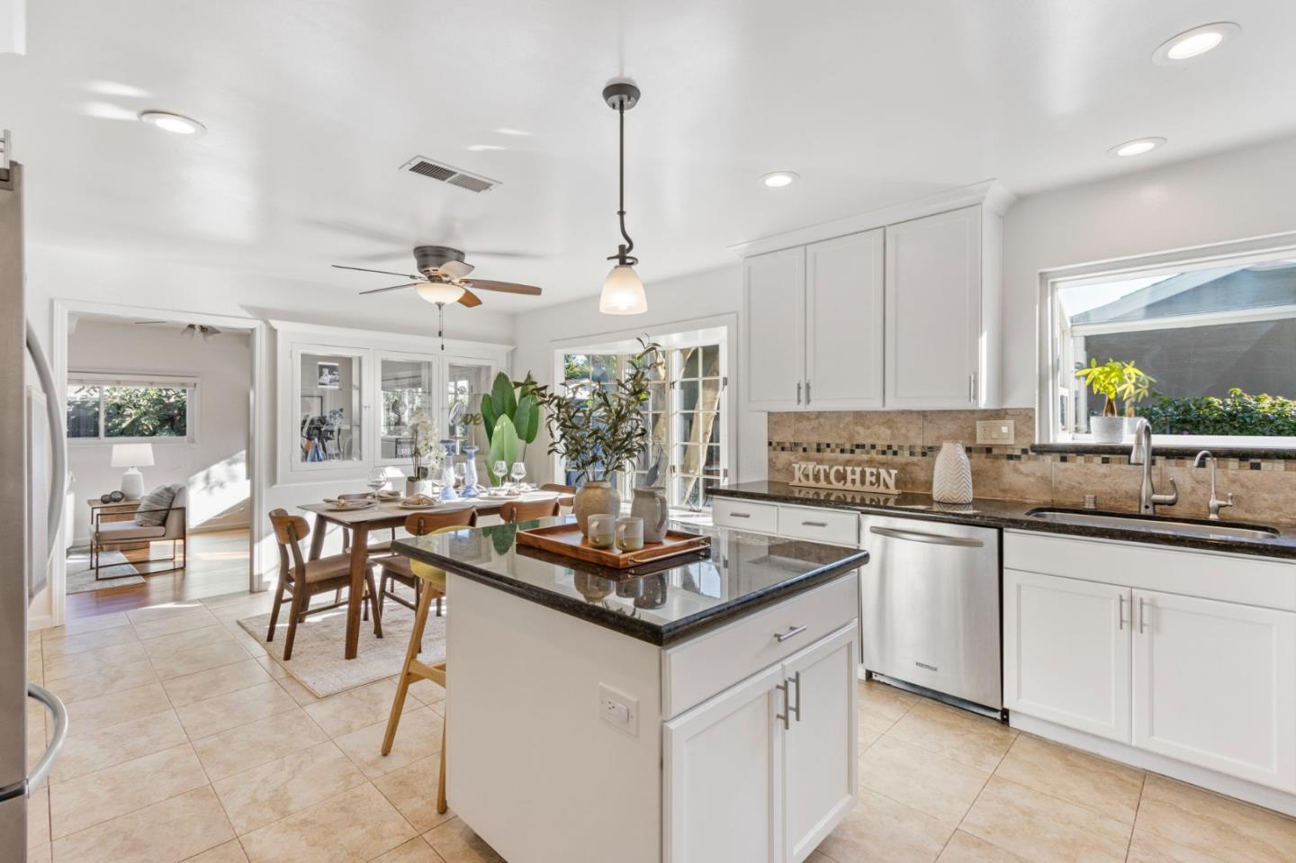 618 Azule Avenue San Jose, CA 95123 - Photo 10 of 48 a kitchen with kitchen island granite countertop a table chairs sink and cabinets
