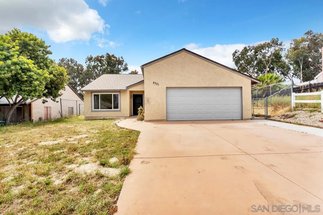 a front view of the house with a yard and garage