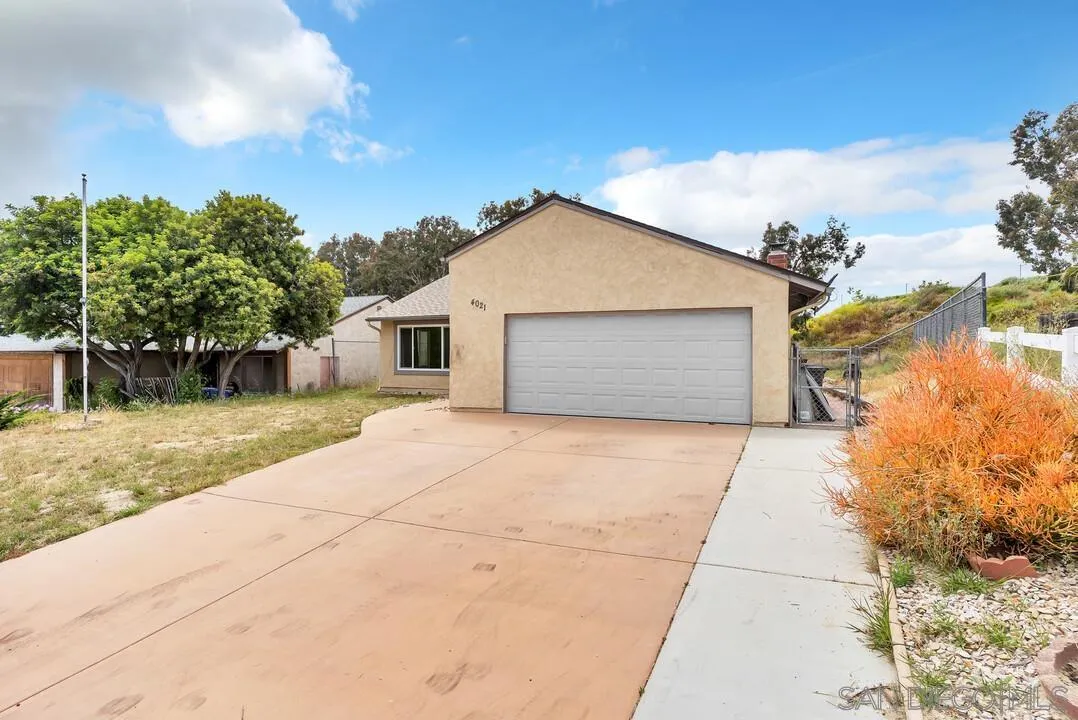 4021 Johnson Drive Oceanside, CA 92056 - Photo 2 of 25 a front view of a house with a yard and garage