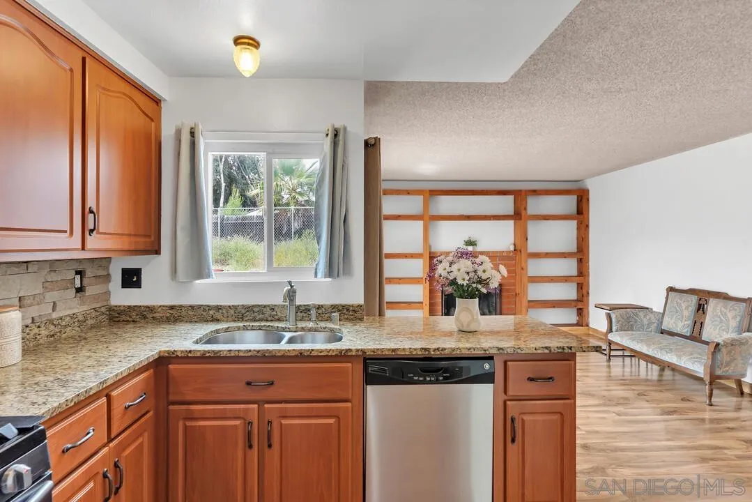 4021 Johnson Drive Oceanside, CA 92056 - Photo 10 of 25 a kitchen with granite countertop a stove a sink and a granite counter tops