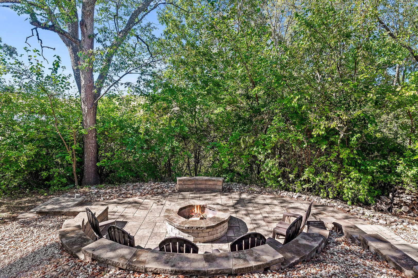 2296 Deer Ridge Court Carlock, IL 61725 - Photo 11 of 59 a view of a backyard with table and chairs potted plants and large tree