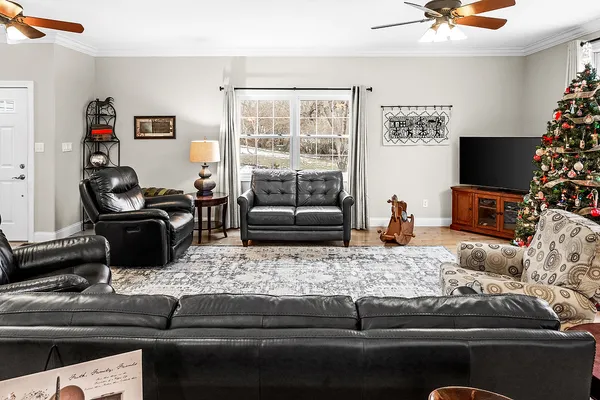 a kitchen with stainless steel appliances kitchen island granite countertop a table chairs and a refrigerator