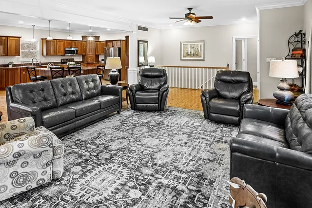 a kitchen with stainless steel appliances granite countertop a stove a sink dishwasher and a microwave oven with large wooden cabinets