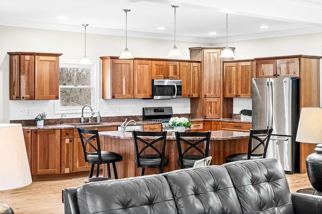 a kitchen with stainless steel appliances granite countertop a refrigerator stove and sink