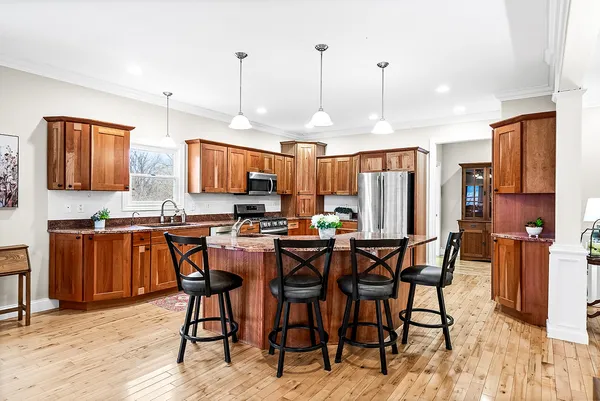 a dining room with furniture a rug and wooden floor