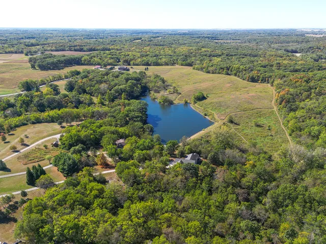 an aerial view of residential houses with outdoor space and ocean view