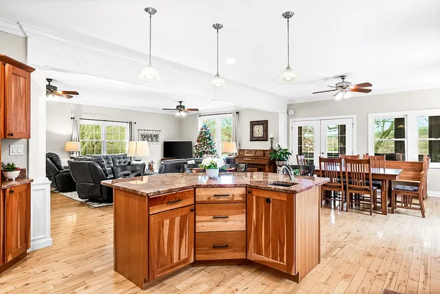 a bedroom with a bed table chair and a potted plant