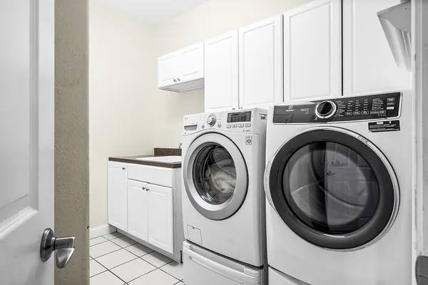 a room with a table chairs and windows