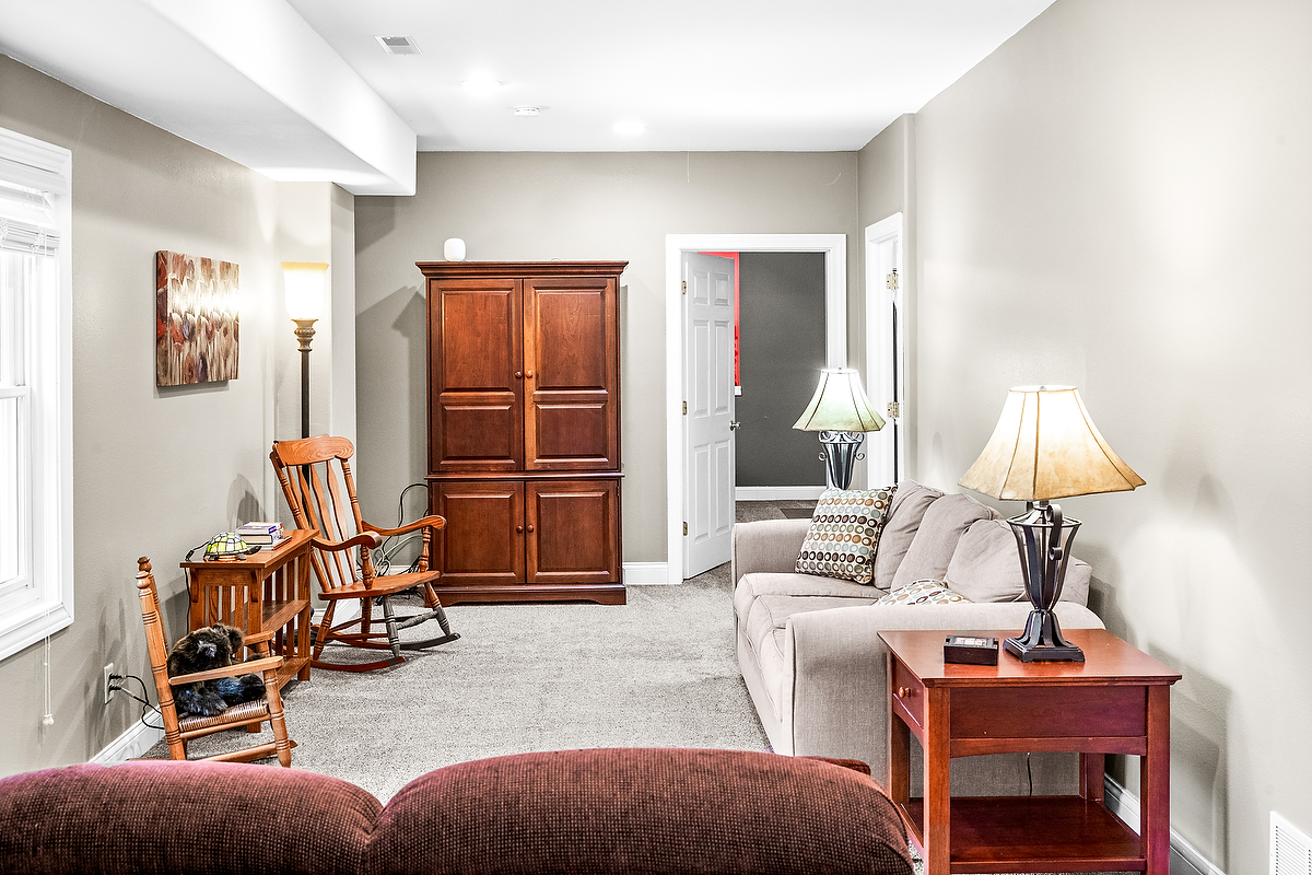 2296 Deer Ridge Court Carlock, IL 61725 - Photo 38 of 59 a living room with furniture and a lamp