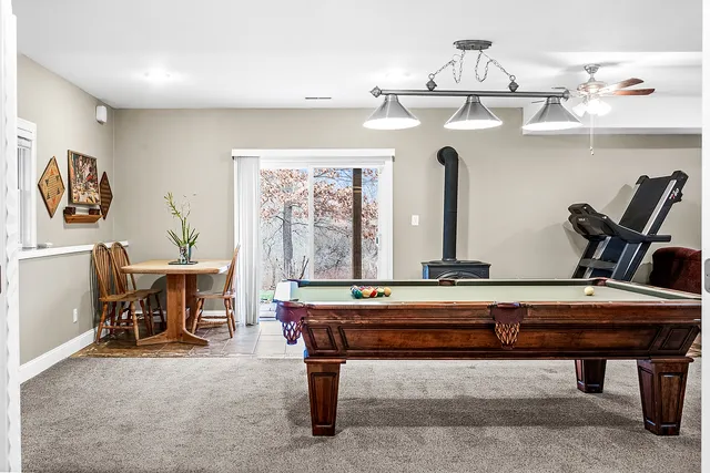 a living room with furniture and flat tv screen