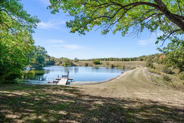 a view of a yard with swimming pool and sitting area