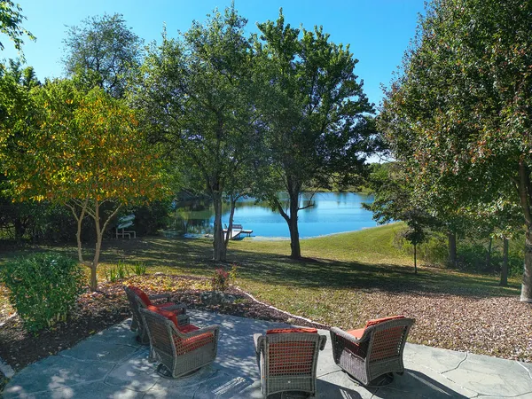 an outdoor sitting area with couch and wooden fence