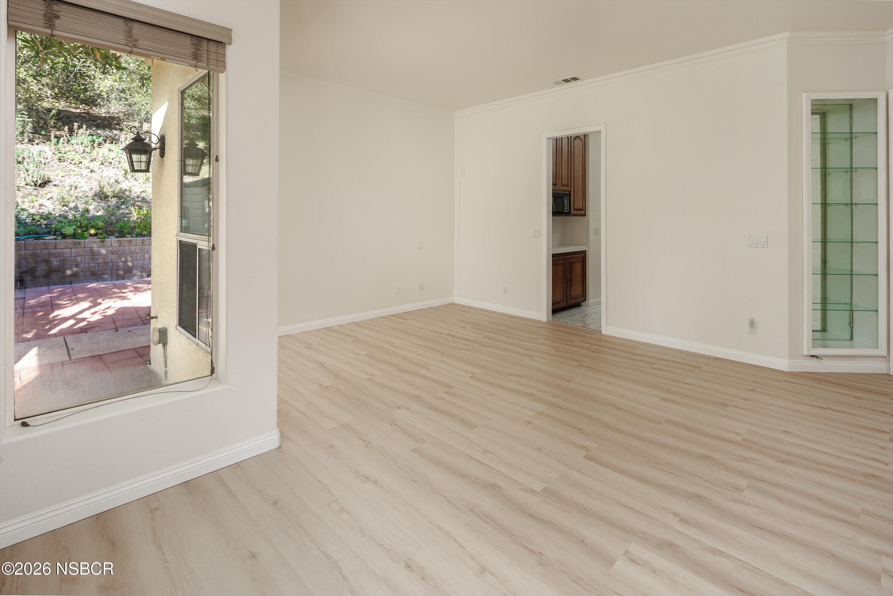 2655 Adobe Falls Road Lompoc, CA 93436 - Photo 26 of 51 a view of an empty room with wooden floor and a window