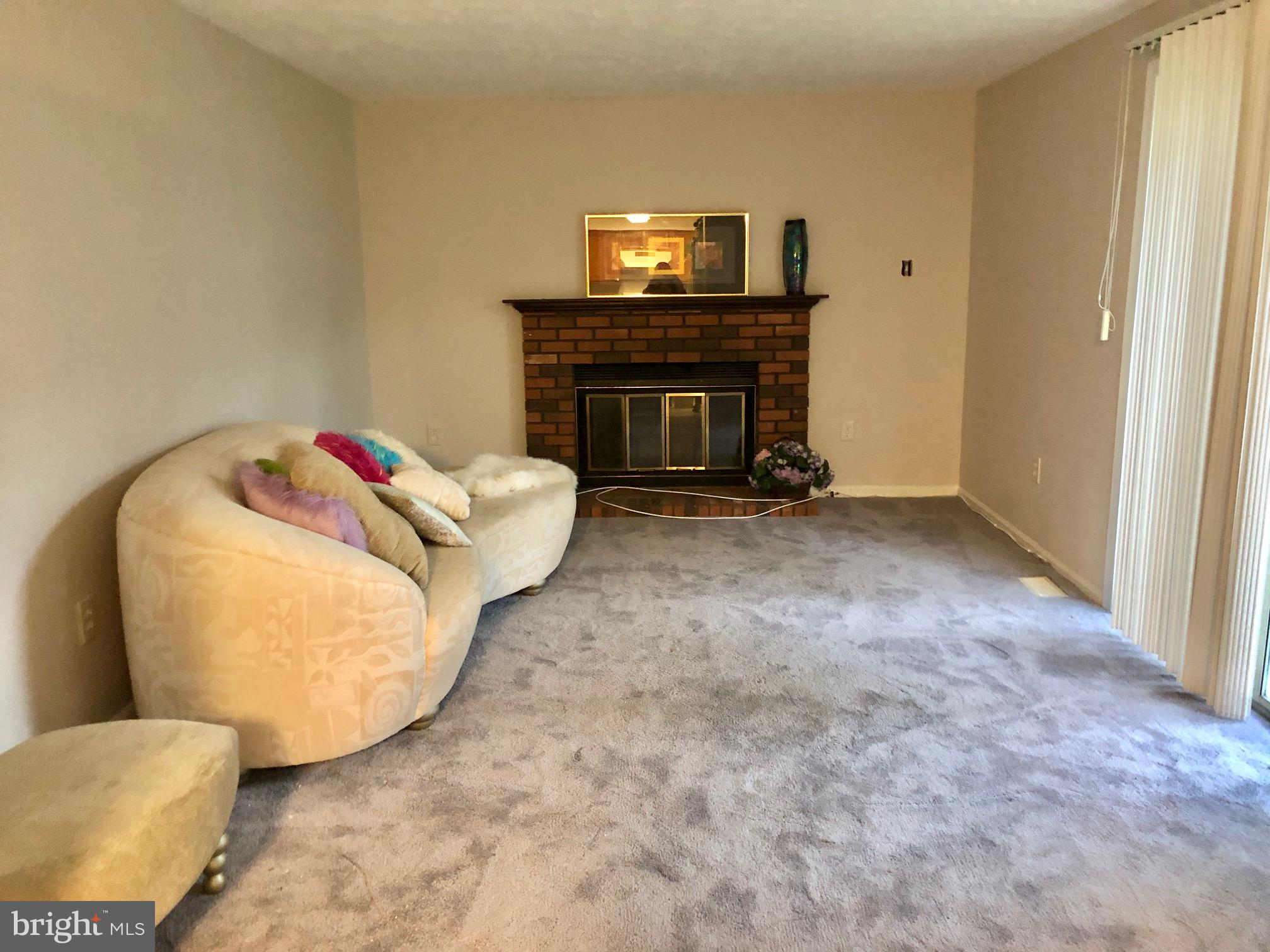 2 Cinnabar Court Gaithersburg, MD 20879 - Photo 12 of 46 a living room with furniture and a fireplace