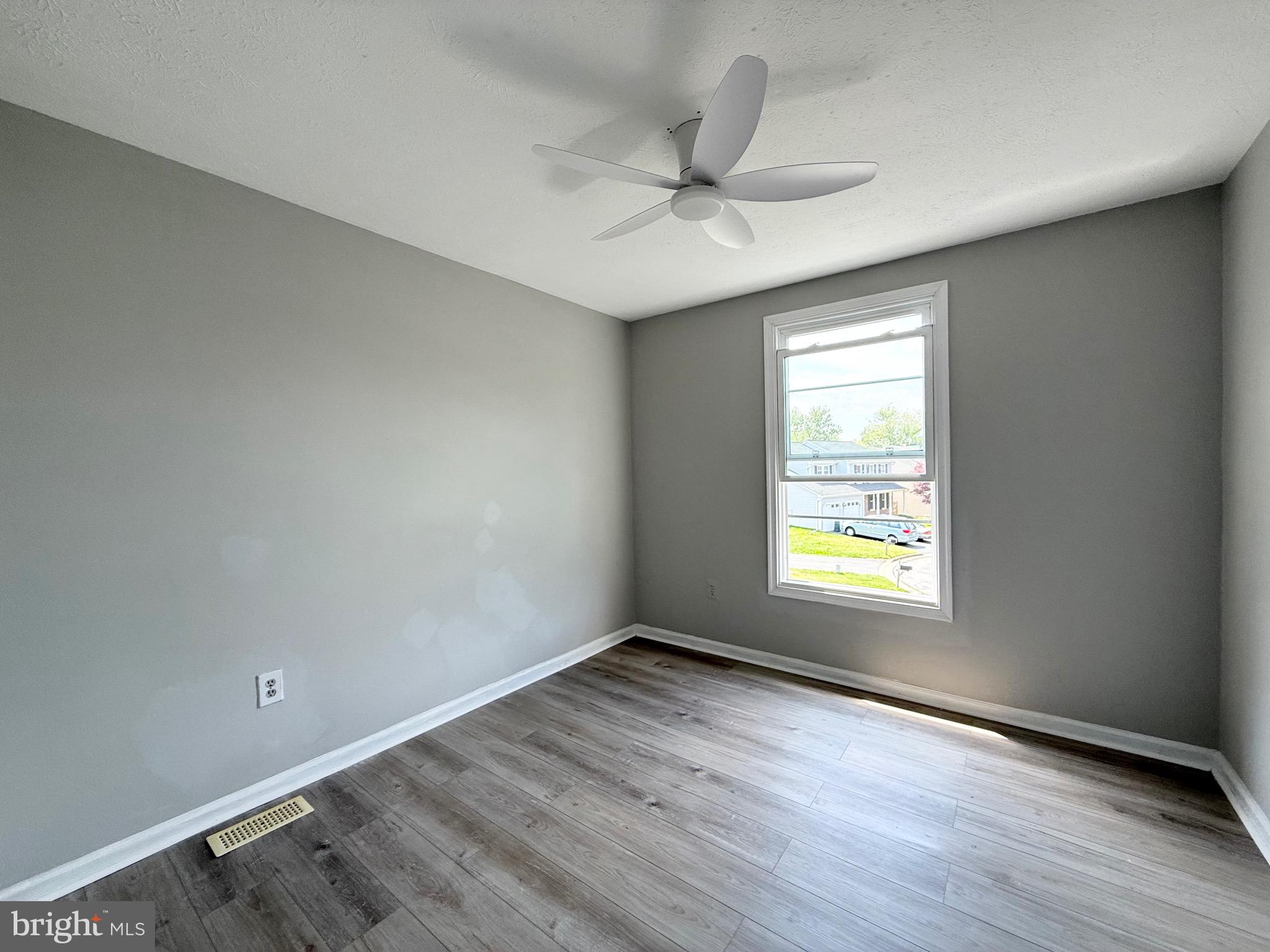 2 Cinnabar Court Gaithersburg, MD 20879 - Photo 31 of 46 an empty room with wooden floor fan and windows