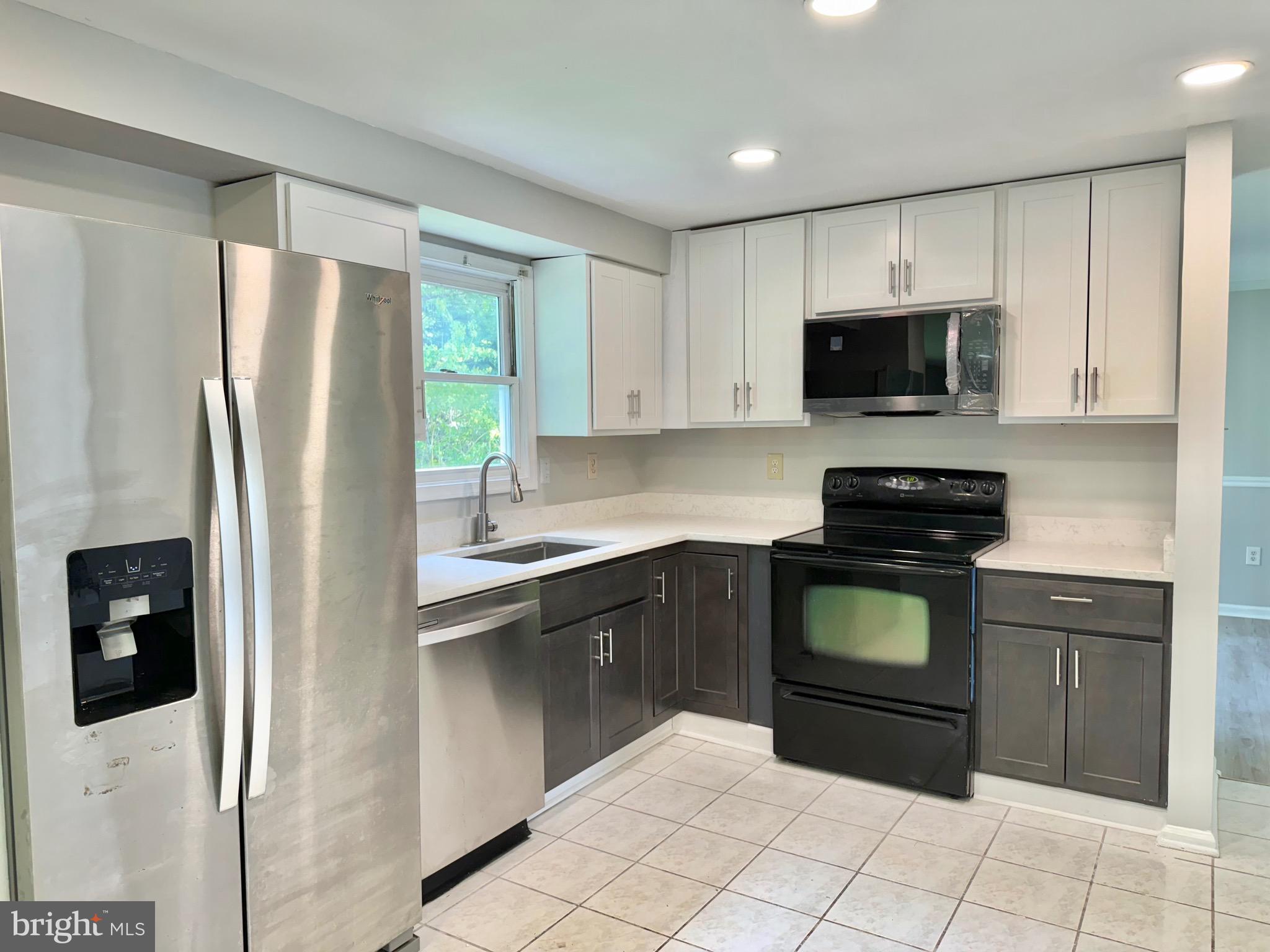 2 Cinnabar Court Gaithersburg, MD 20879 - Photo 5 of 46 a kitchen with a refrigerator and a stove top oven