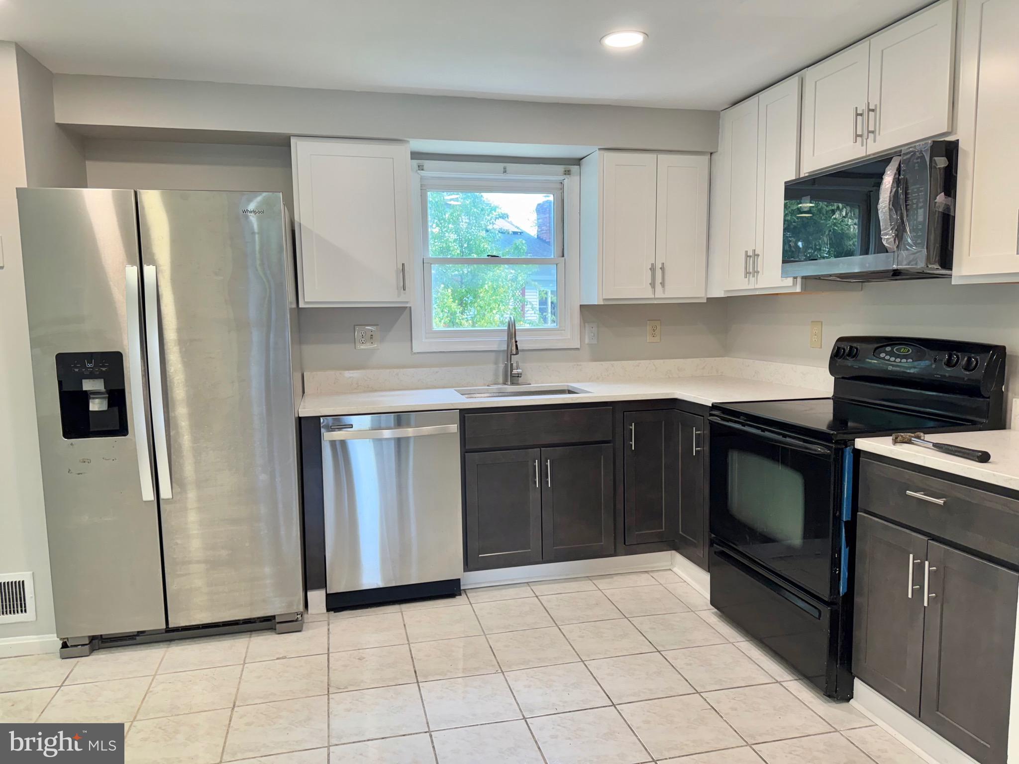 2 Cinnabar Court Gaithersburg, MD 20879 - Photo 7 of 46 a kitchen with stainless steel appliances granite countertop a refrigerator sink and stove
