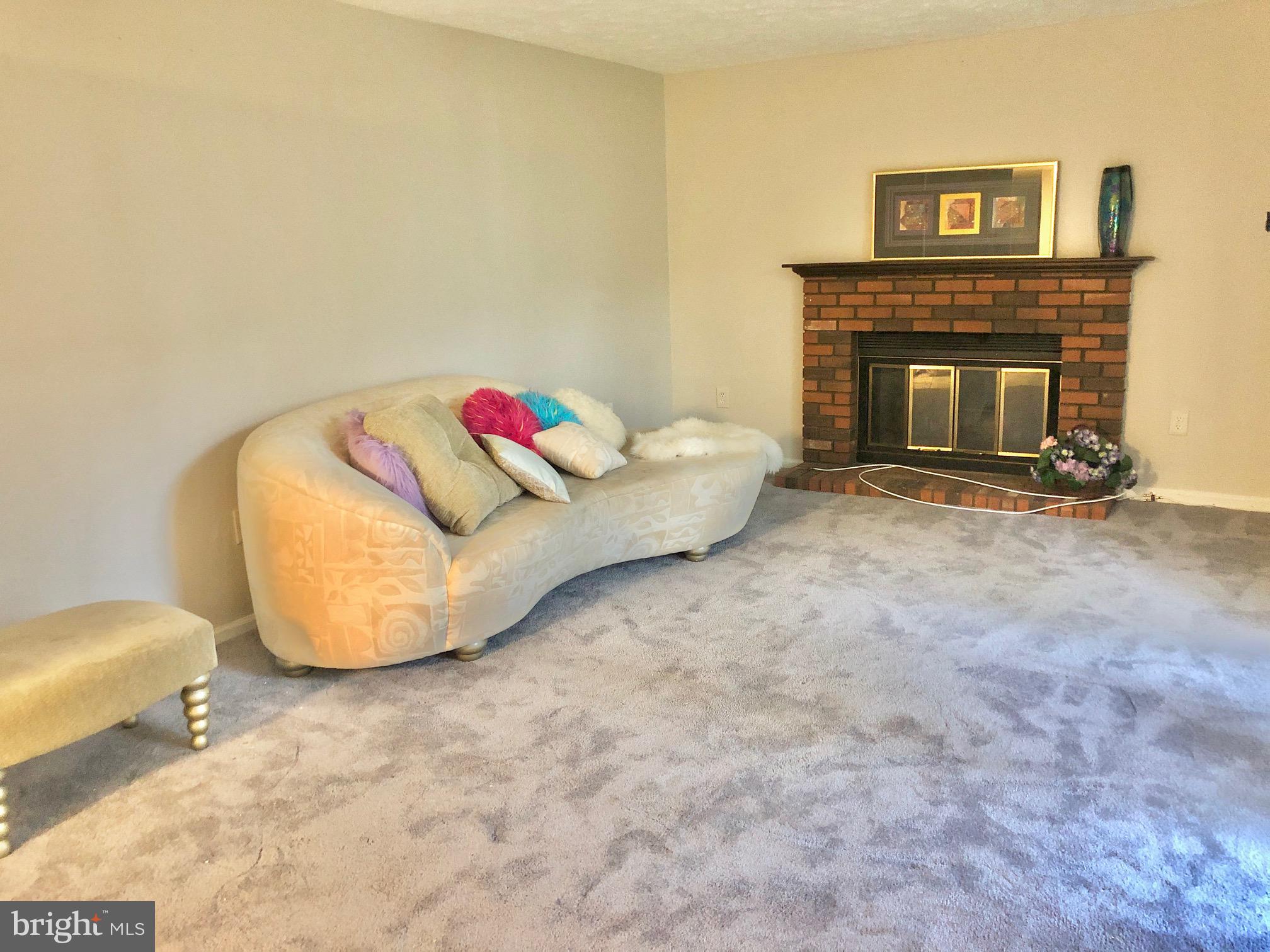 2 Cinnabar Court Gaithersburg, MD 20879 - Photo 10 of 46 a living room with furniture and a fireplace