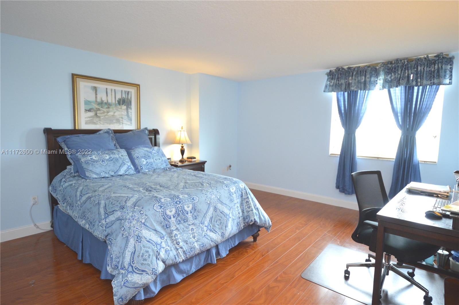 3000 Coral Way, Unit 521 Miami, FL 33145 - Photo 13 of 24 a bedroom with a bed and a table