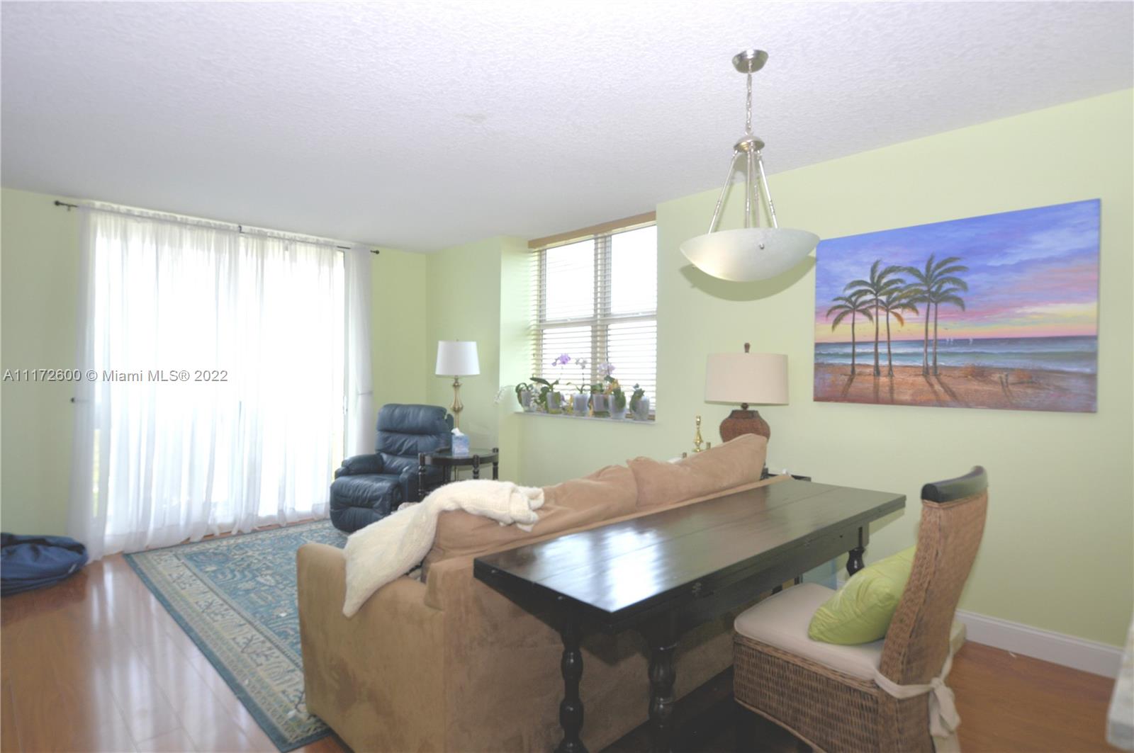 3000 Coral Way, Unit 521 Miami, FL 33145 - Photo 8 of 24 a living room with furniture chandelier and a window