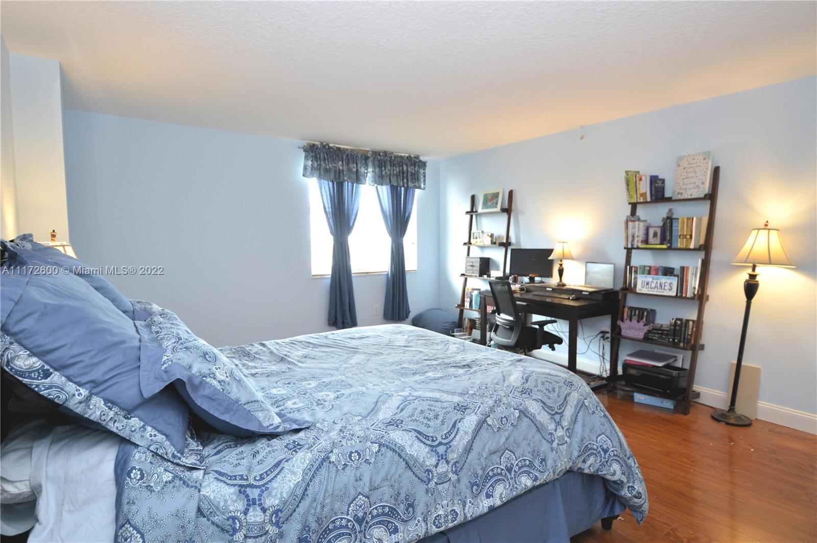 3000 Coral Way, Unit 521 Miami, FL 33145 - Photo 10 of 24 a bedroom with a bed a table and a large mirror