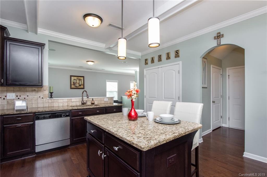 7059 Meyer Road Fort Mill, SC 29715 - Photo 11 of 30 a kitchen with granite countertop a sink cabinets and wooden floor