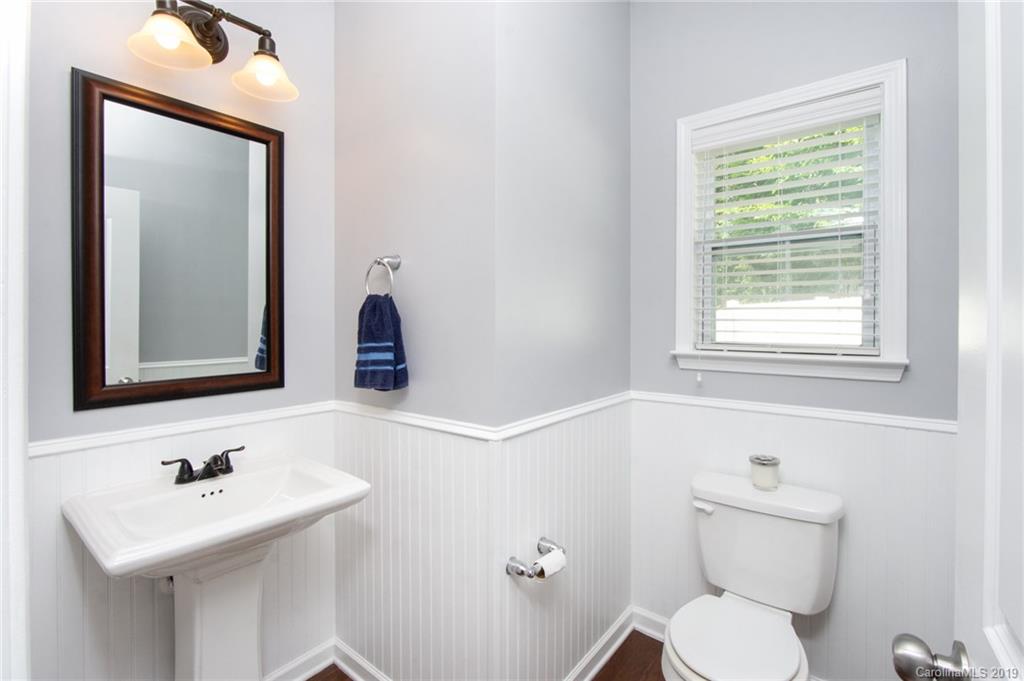 7059 Meyer Road Fort Mill, SC 29715 - Photo 13 of 30 a bathroom with a toilet a sink and mirror