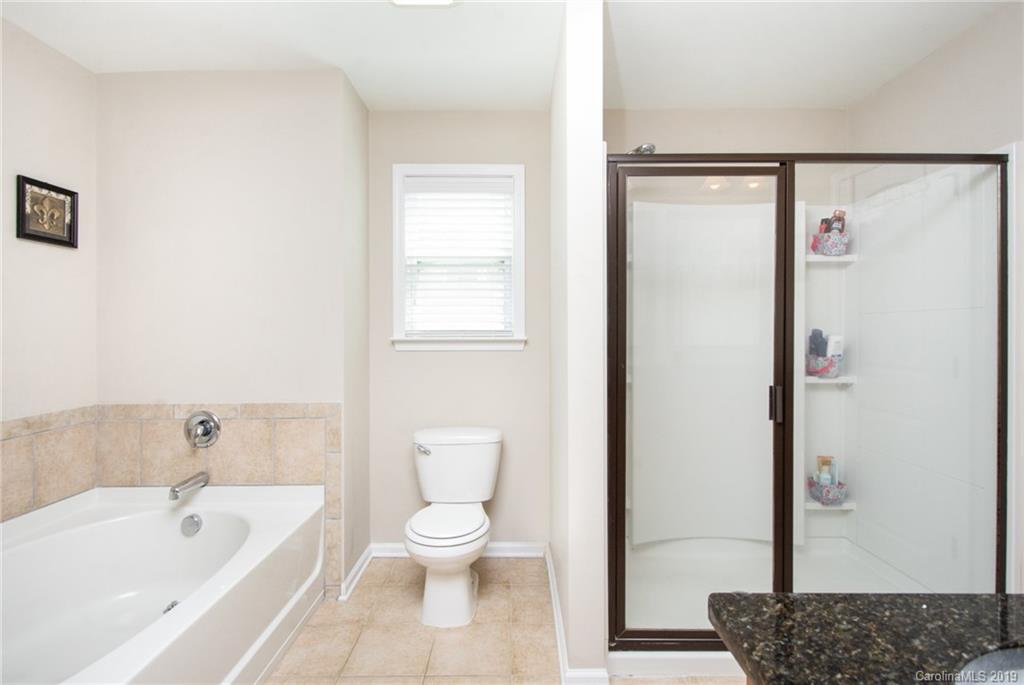 7059 Meyer Road Fort Mill, SC 29715 - Photo 18 of 30 a bathroom with a toilet a sink and bathtub