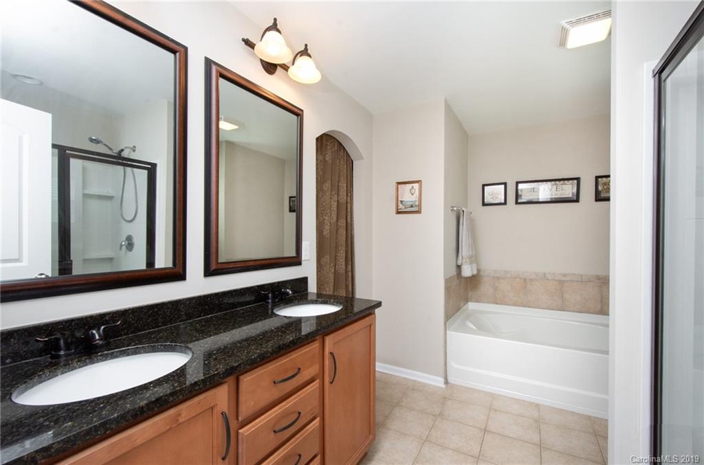 7059 Meyer Road Fort Mill, SC 29715 - Photo 19 of 30 a bathroom with a granite countertop sink and a mirror