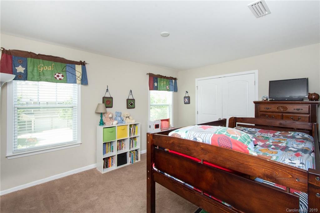 7059 Meyer Road Fort Mill, SC 29715 - Photo 21 of 30 a bedroom with a bed and a dresser in it