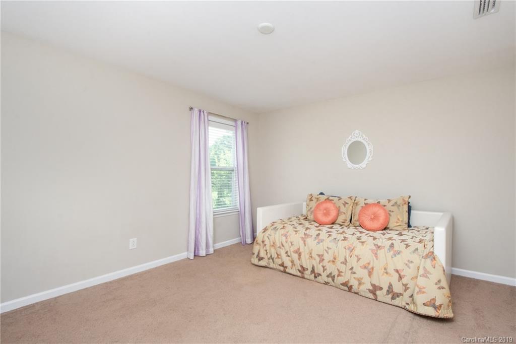 7059 Meyer Road Fort Mill, SC 29715 - Photo 23 of 30 a bedroom with a bed and window