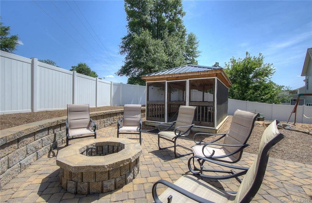 7059 Meyer Road Fort Mill, SC 29715 - Photo 26 of 30 a view of a patio with a dining table and chairs with a fire pit